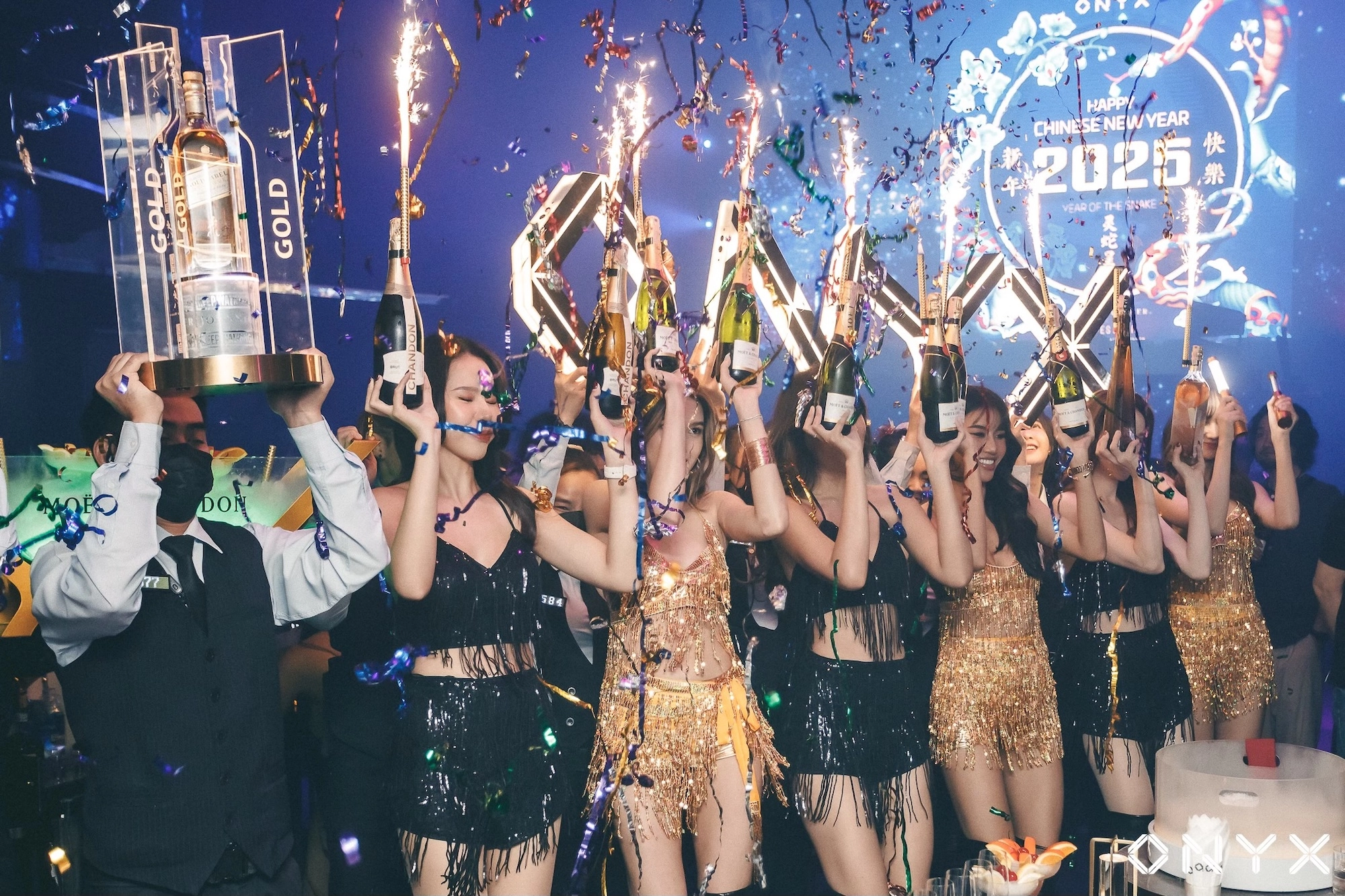 bottle girls bringing Moet and Chandon Champagne bottles to a VIP table at Onyx nightclub in RCA Bangkok