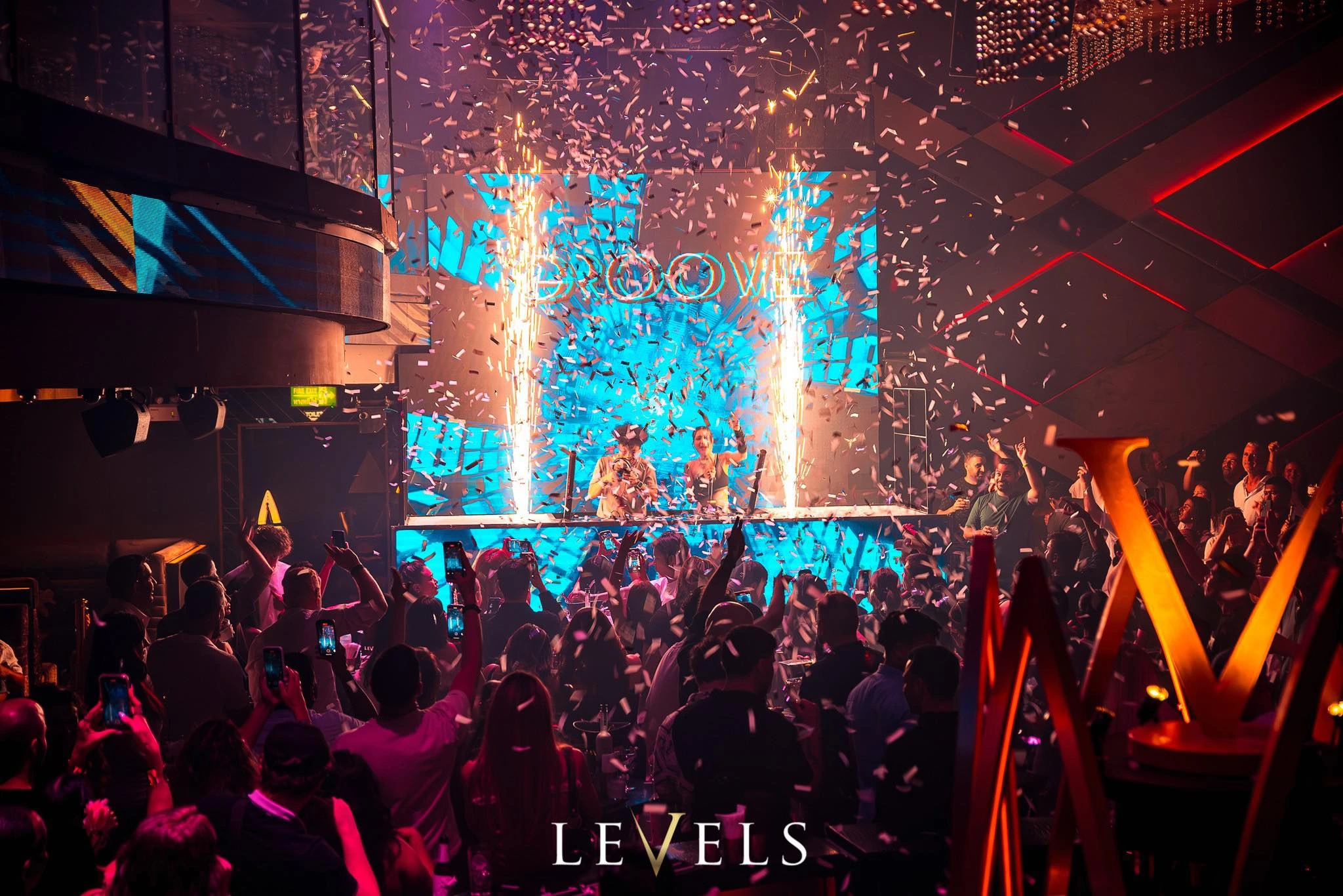 Two DJs performing on the main scene and people partying in Levels Club in Sukhumvit 11 in Bangkok