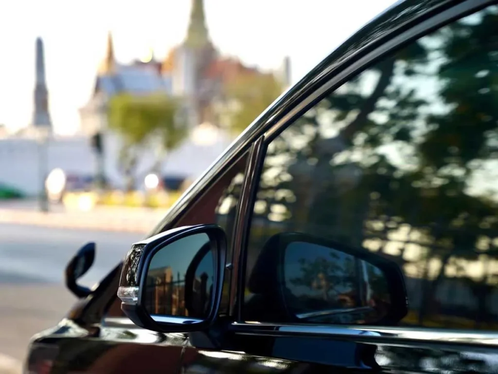 luxury private car parked near a temple in bangkok for guided city tour