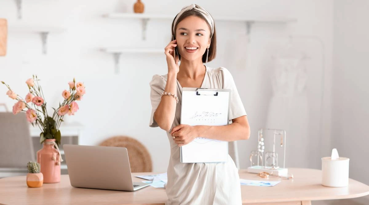Lady on the phone holding a clipboard in an office