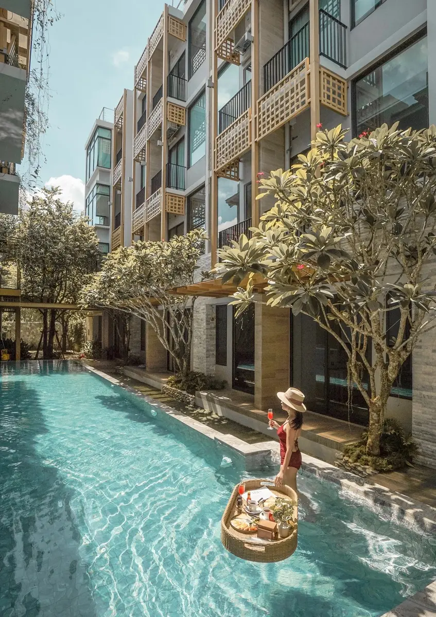 Lady taking her breakfast in the swimming pool of a modern design hotel