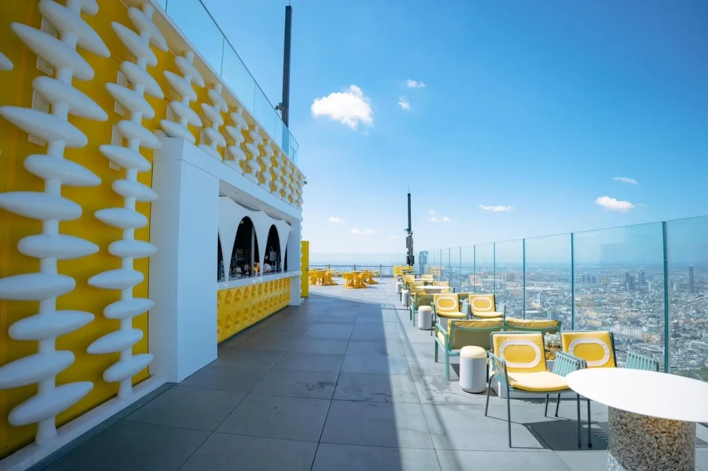 Vibrant yellow bar at the highest rooftop bar in Bangkok, offering a stunning 360-degree view of the city