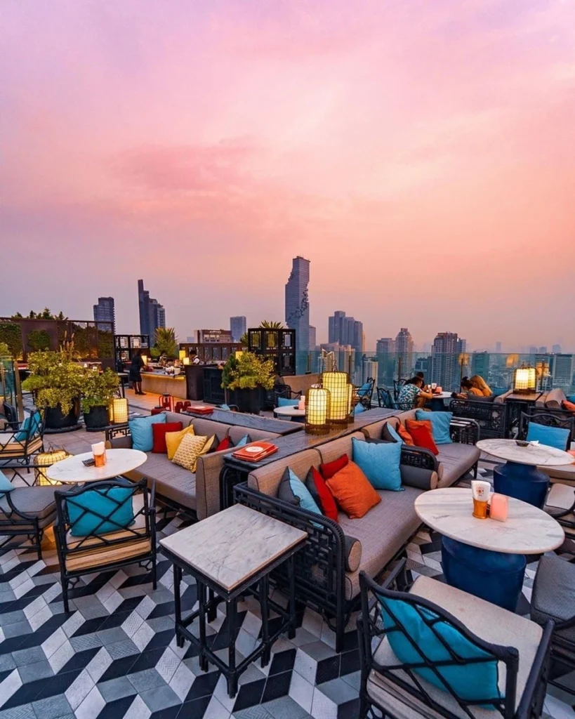 Lounge sofas and table with a stunning city view from Yao Rooftop Bar in Bangkok